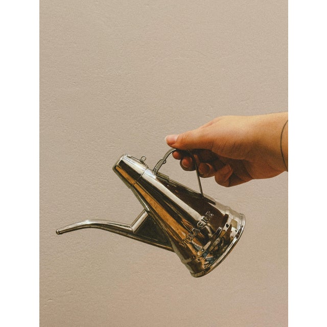 Pair of stainless steel oil and vinegar cruets, classic tableware objects typical of Portuguese taverns and everyday...