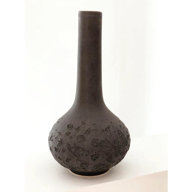 A medium sized lab bottle vase glazed in a rich matte slate with nice cratering on the lower half. Water tight by Sara...