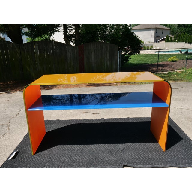 Add a bold burst of modern sophistication to your space with this striking postmodern multi-color acrylic console table....