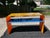 Add a bold burst of modern sophistication to your space with this striking postmodern multi-color acrylic console table....