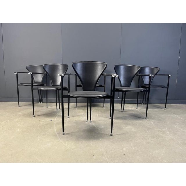 Set of 6 italian dining chairs consisting of black metal frames with black leather backrests and seats and beautiful...