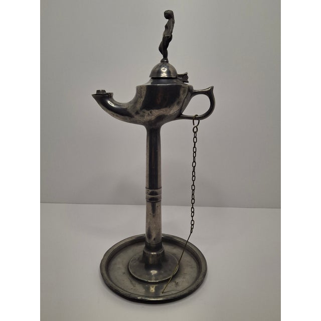 Up for sale are a pair of antique pewter whale oil or fat lamps, likely from the mid- to late 19th century, hinged lids on...