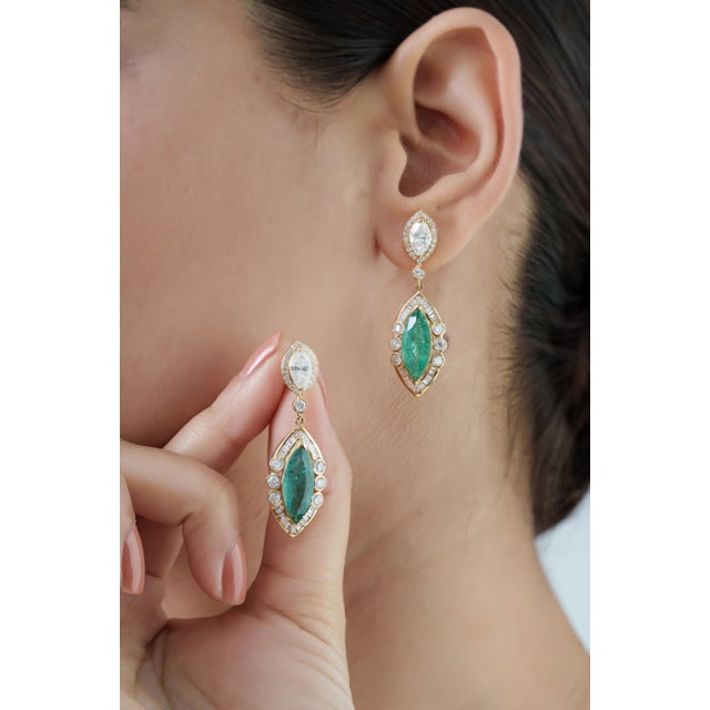 These elegant drop earrings showcase 6.9 carats of natural marquise-cut emeralds set in 14K Yellow Gold. Each emerald...
