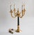 Italian vintage four-lamp candelabra-type table lamp in gilded bronze and black marble with round mini shades. The...