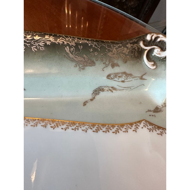 Fish serving set. French porcelain, Haviland & Co. Limoges. Late 19th century. Green ground with gold and silver gilt....