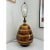 A Mid-Century Modern 1960's pottery lamp in a swirled fat lava drip glaze in warm amber and brown tones. The smooth shiny...