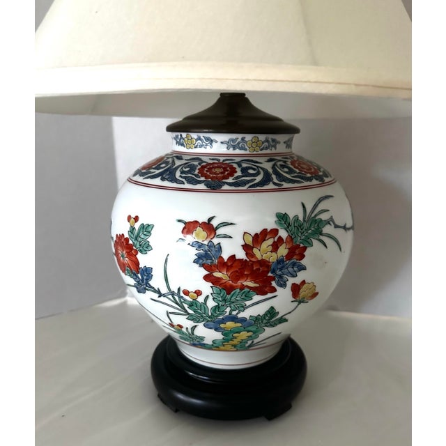 Stunning vintage Asian porcelain ginger jar lamp on a wood base. Quality made, sturdy lamp with a silk shade from...