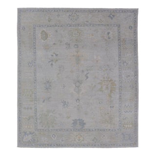 Modern Tribal Oushak With a Cream Border and Light Gray-Blue Background For Sale