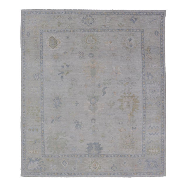 Modern Tribal Oushak With a Cream Border and Light Gray-Blue Background For Sale