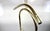 A stylish mid-century Hollywood Regency valet stand featuring a polished brass-finished metal frame with an elegant faux...