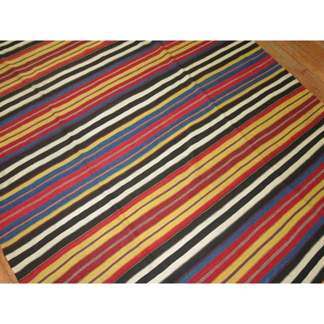 An intermediate size striped finer quality Vibrant Persian Kilim from the early stages of the 20th century, circa 1920,...