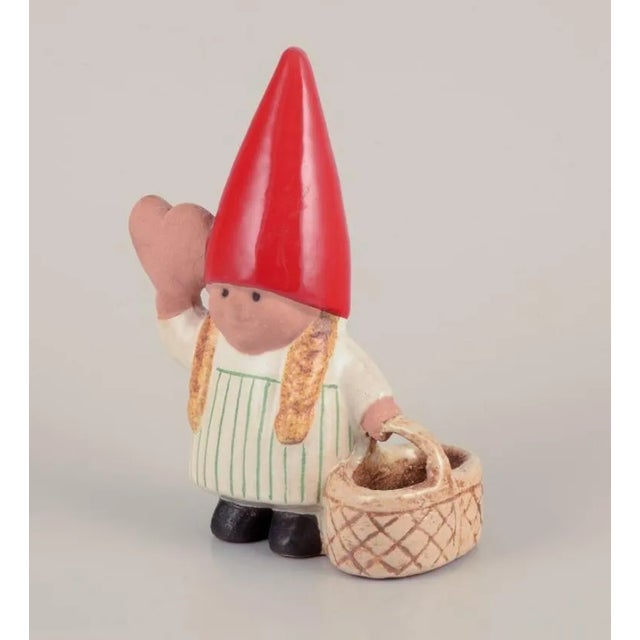 Lisa Larson for Gustavsberg. Elf girl with braided basket and honey heart. Late 20th century. In perfect condition....