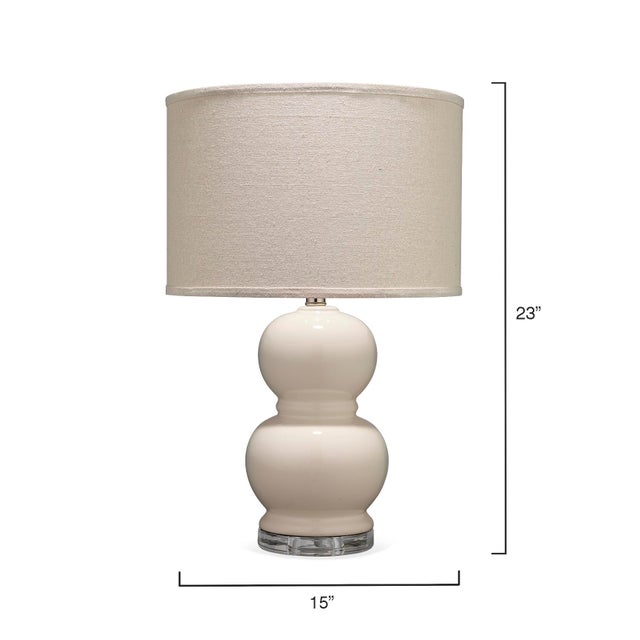 Classic shaped smooth ceramic table lamp in a soft neutral tone makes this lamp the perfect transitional piece. Finial and...