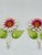 This is a pair of vintage metal wall hooks designed with decorative daisy flowers and green leaves. Each hook features...