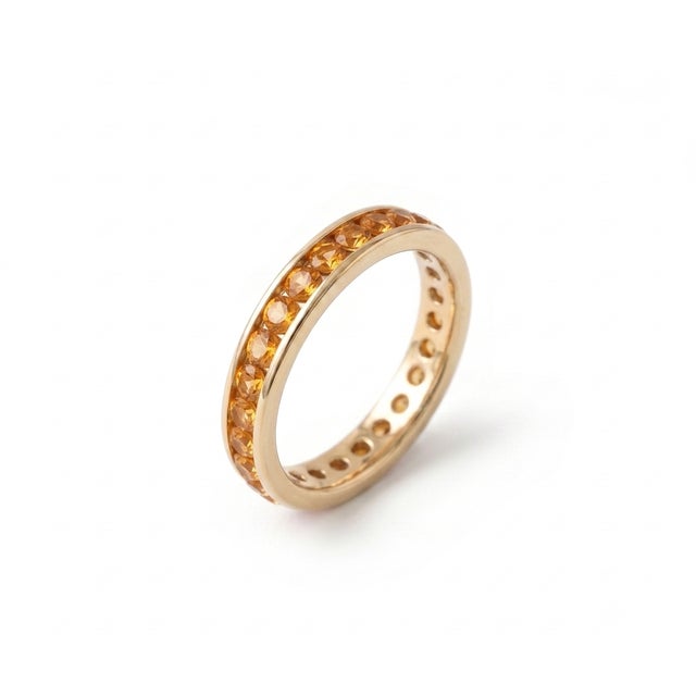 Capture the warmth of golden sunshine with this exquisite full eternity band, designed to showcase a continuous, radiant...