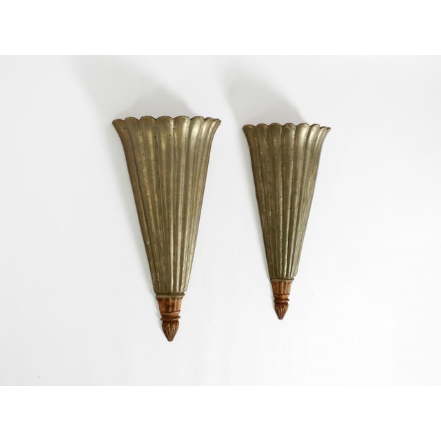A pair of large, rare, wooden wall lamps from the 1950s. Clad on the exterior with thin sheet aluminum. Striking...