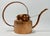 Vintage sculptural hammered copper watering can with a rounded body and prominent handle and spout. Lovely patina.