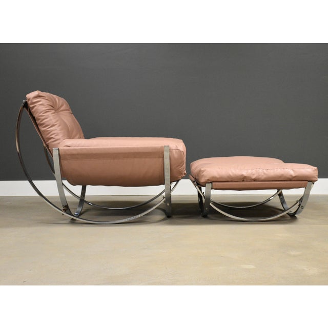 A mid century modern pink vinyl sling lounge chair and ottoman with a chromed steel frame made by Stendig. Made in Italy....
