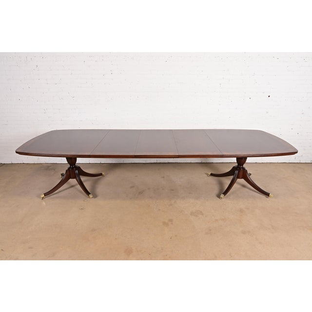 An exceptional Georgian or Regency style double pedestal extension dining table By John Widdicomb USA, Circa 1980s...