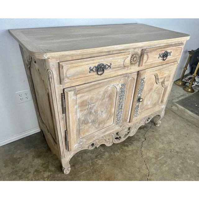 8th C. Carved French Provincial buffet with original metal hardware. The buffet stands on four cabriole legs. There is a...