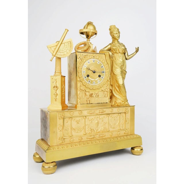 A French Empire gilt-bronze mantel clock It is a great example of early 19th-century decorative arts in France. These...