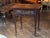 An English side table of lowboy proportions, the long frieze drawer centered by a fluted shell within richly scrolling...