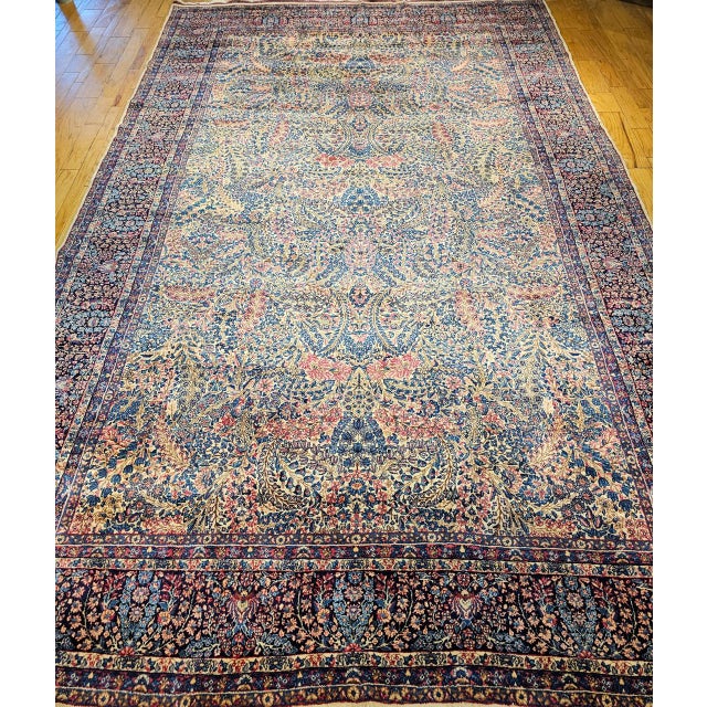 A beautiful oversized Persian Kerman Lavar carpet in the iconic Millefleur — or 'million flowers' — allover design, one of...