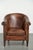 This sturdy vintage sheepskin club armchair features a rich patina and an authentic vintage appearance, and is finished...