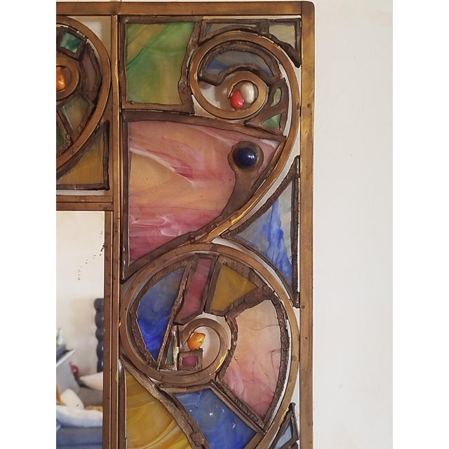 Sculptural mirror made of laminated glass paste, metal, and a worked brass frame. The creation process is long and...