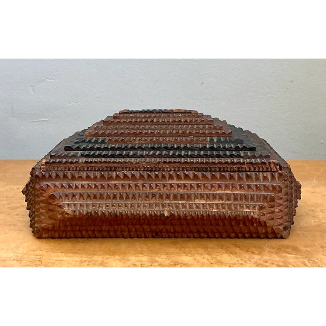 Showcasing quintessential American folk art craftsmanship, this antique tramp art box features complex, multi-layered chip...