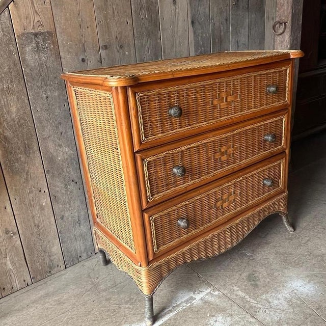 The chest has 3 drawers with twisted wicker handles. Wicker covers the top, front and sides & has finished around the...