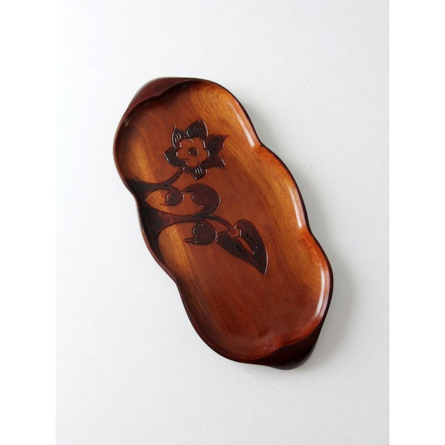 This vintage carved wood tray from the 1960s–1970s reflects the warmth and character of Caribbean folk craft. Finished in...