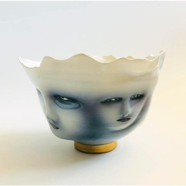 A large porcelain art pottery bowl by California ceramicist, Bing Gleitsman. Features a design of four 3 dimensional faces...
