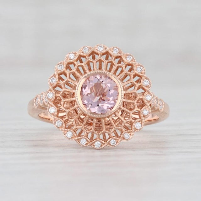 This beautiful halo ring is a Beverley K piece. Gem: Natural Morganite - 0.55 Carats, Round Cut, Peachy Pink Color -...