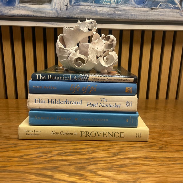 A refined coastal book vignette curated in soft blues, creams, and natural neutrals—designed to bring effortless...