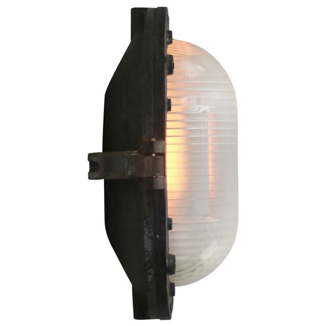 French industrial wall / ceiling lamp by holophane, france grey cast iron with frosted cut glass. e27 / e26 this piece has...