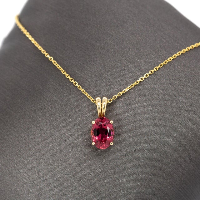 Elegant yet full of personality, this 1 carat pink tourmaline solitaire pendant features a softly faceted oval gemstone...