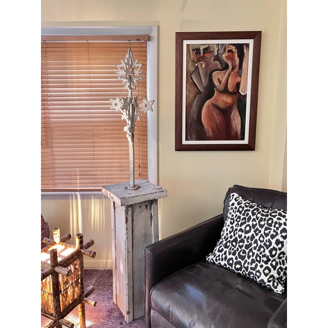 A large "widow's walk" architectural element in painted iron mounted to a painted wood base. The paint has weathered to...