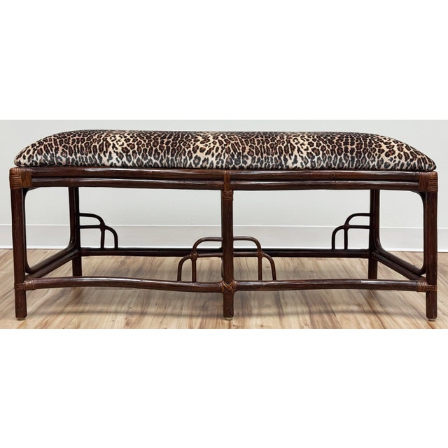 Vintage Chinoiserie style upholstered bentwood rattan bench. Features sturdy curved frame with six legs reinforced by...
