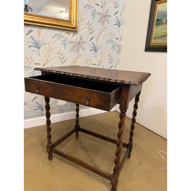 Such a lovely piece of history, this side table features distinctive barley twist legs and a delicate scalloped top. This...