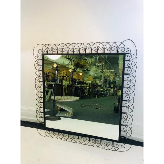 Unusual midcentury iron mirror, 1960’s. Measures 45” high by 45” wide. In good vintage condition, some wear and tear...