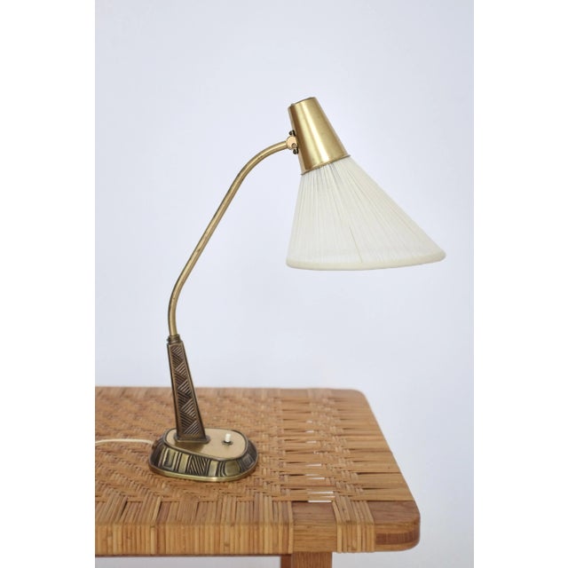 Beautiful 1950's Brass Table lamp Model E1139 by Sonja Katzin for ASEA. Carved striped pattern on the lamp foot with...