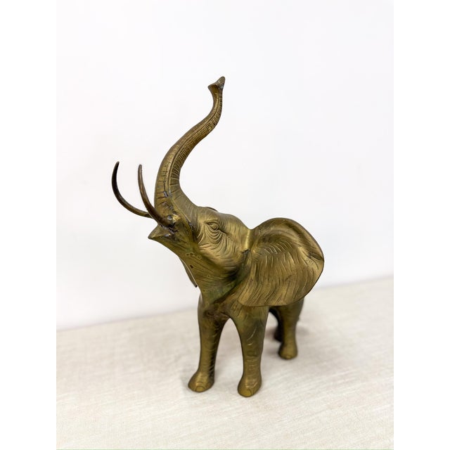 Make a bold statement with this large vintage brass elephant sculpture, featuring a rich natural patina that adds depth,...