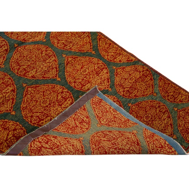 Beautiful Sari handmade silk rug with a blue field. This Modern rug has rust and tan accents featuring a gorgeous all-over...