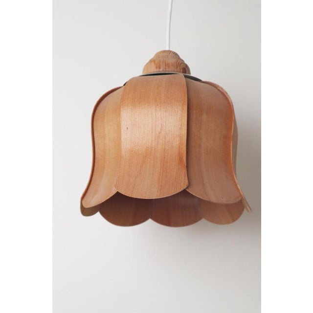 This beautiful and very rare bellflower-shaped pendant lamp is crafted from pine wood. The lamp's design is very...