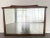 A vintage wall mirror made by White Pine Furniture in the 1970s. This piece features a solid wood frame with sculptural...