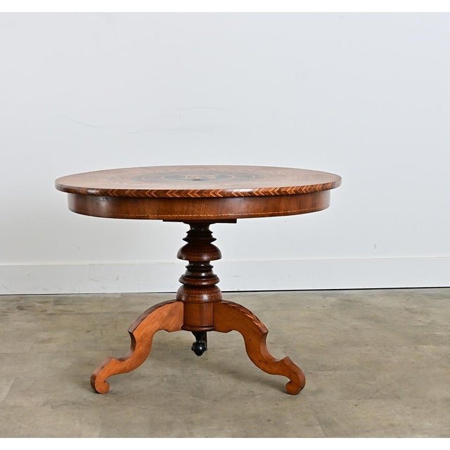 Italian 19th century inlaid walnut and birch center table with geometric marquetry decorating the top in concentric...