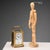 Travel clock in gilt bronze and beveled glass. Visible movement and mechanism. Enamelled metal dial with Roman numeral...