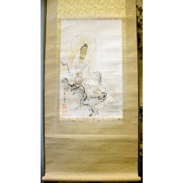 Japanese silk scroll of Fish basket Kannon, Gyoran Kanzeon Bosatsu or Bodhisattva (魚藍観世音菩薩), seated on a rocky shore with...