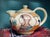 Vintage Renaissance style hand painted teapot features a portrait of a man on one side and a woman on the other with...